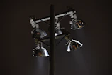 Outdoor LED floodlights casting a strong, clear light over a garden at night.
