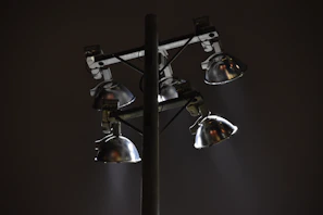 A set of emergency floodlights casting wide beams over an outdoor area at night.