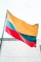 a large rainbow colored flag flying in the wind
