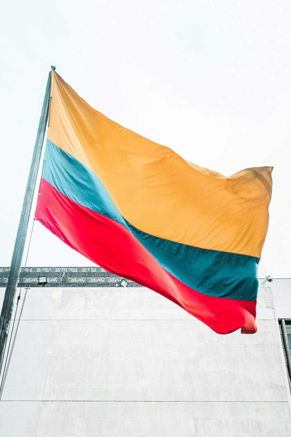 a large rainbow colored flag flying in the wind