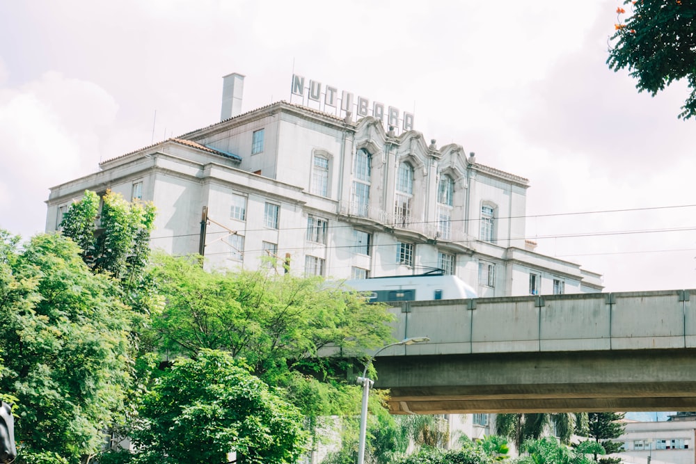 a bridge over a river with a building in the background