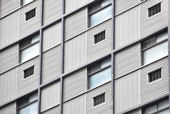 Wide shot of a building featuring a combination of metal framework and ACM panels.