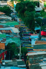 A vibrant aerial view of a South Florida neighborhood with colorful houses and palm trees.