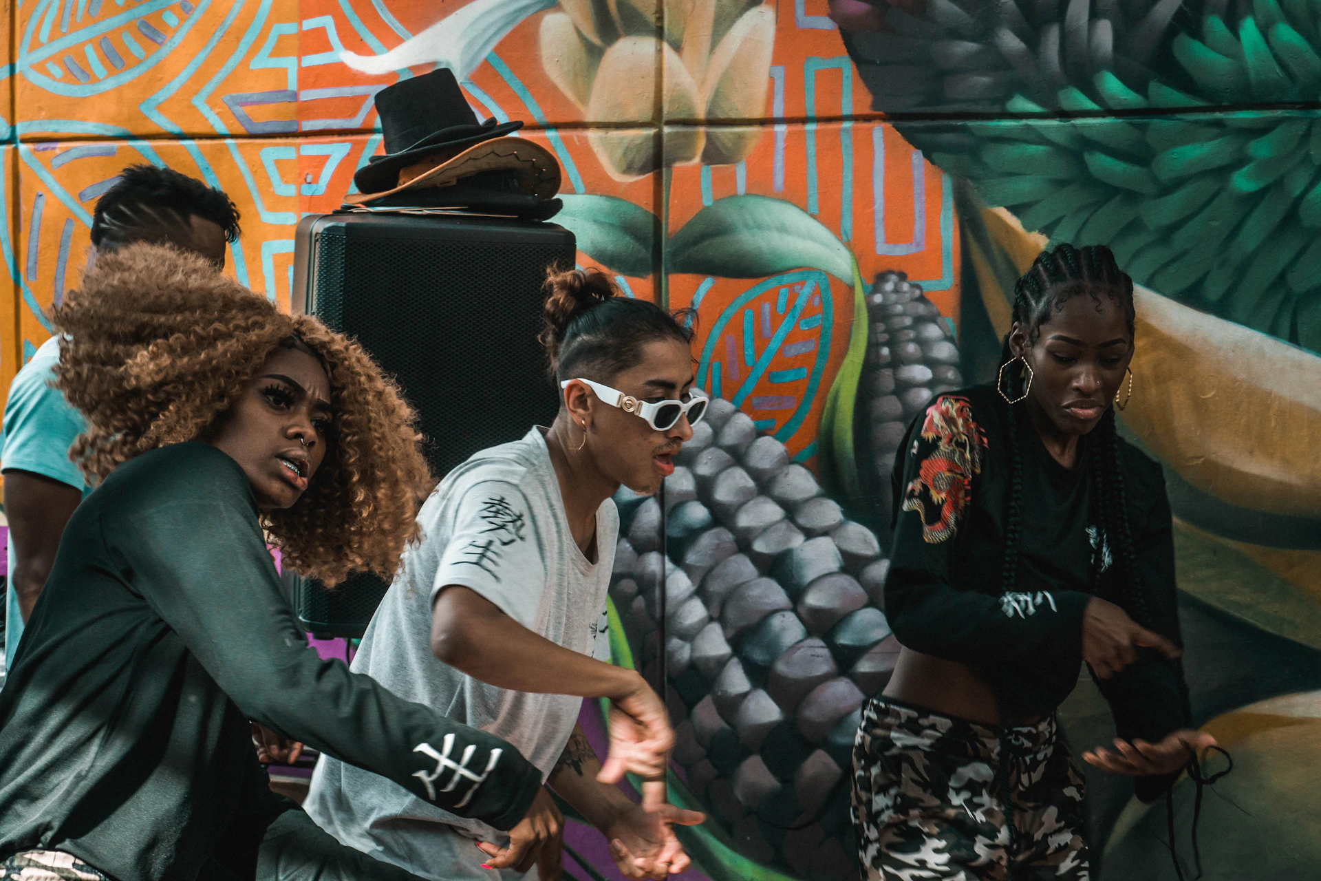 a group of people standing in front of a colorful wall