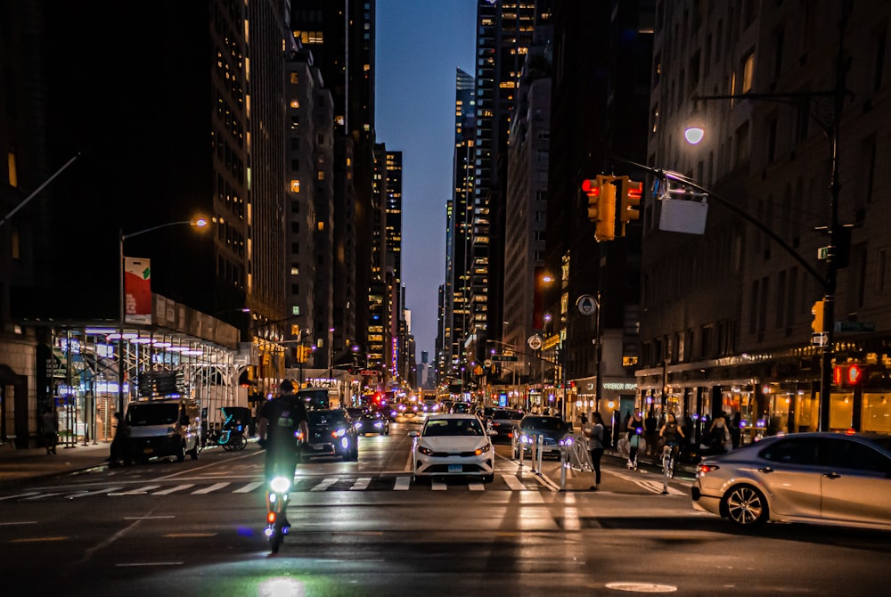 a city street filled with traffic at night