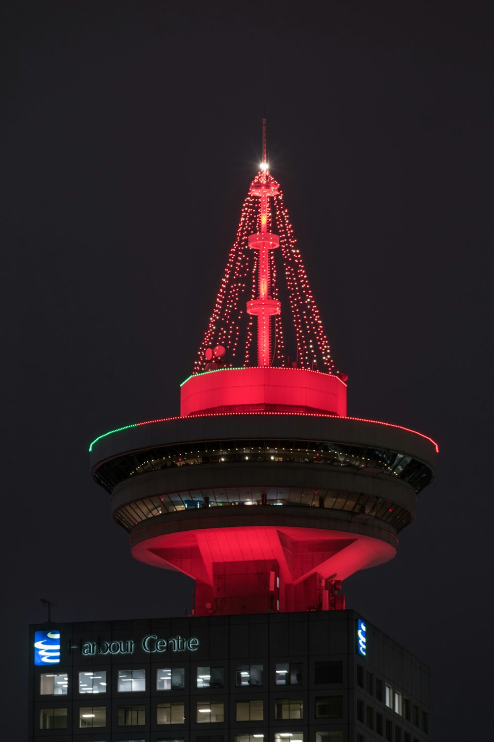 a very tall tower with a lit up christmas tree on top of it
