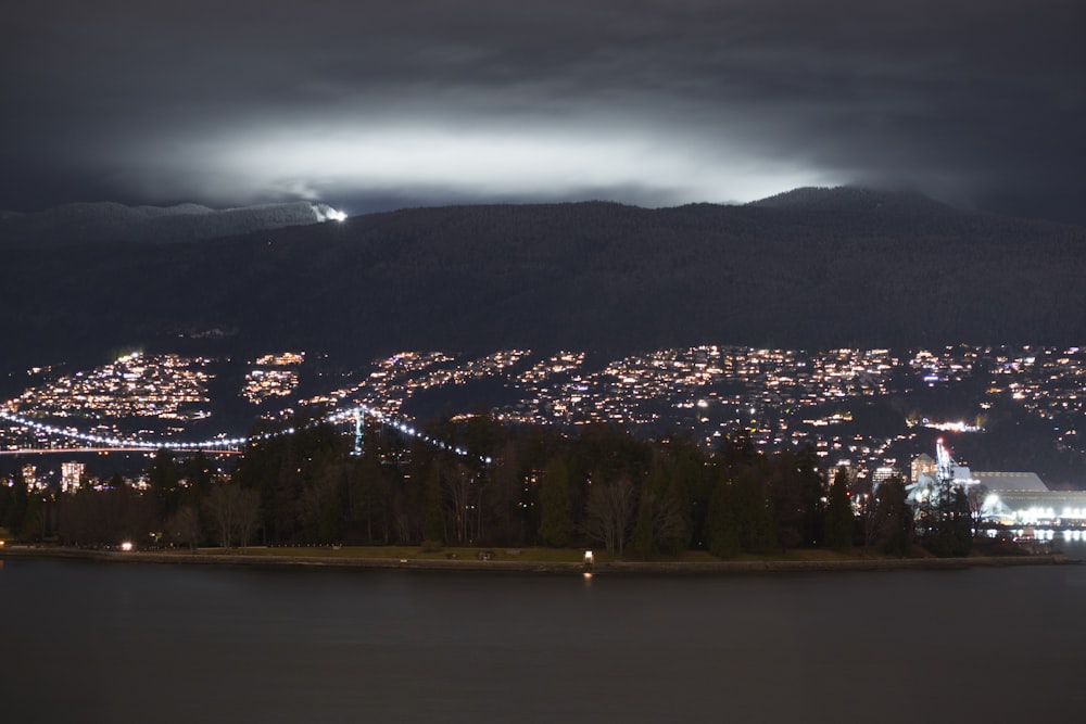 a view of a city at night from across a lake