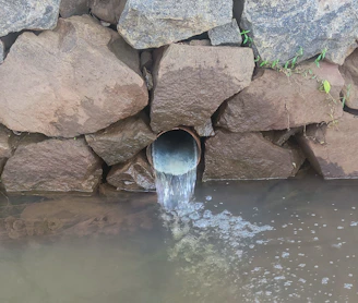 a large pipe is coming out of the water