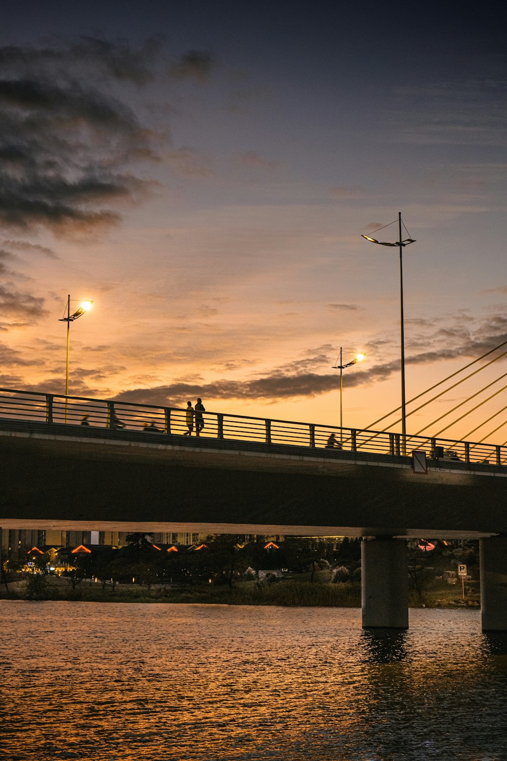 a bridge over a body of water at sunset