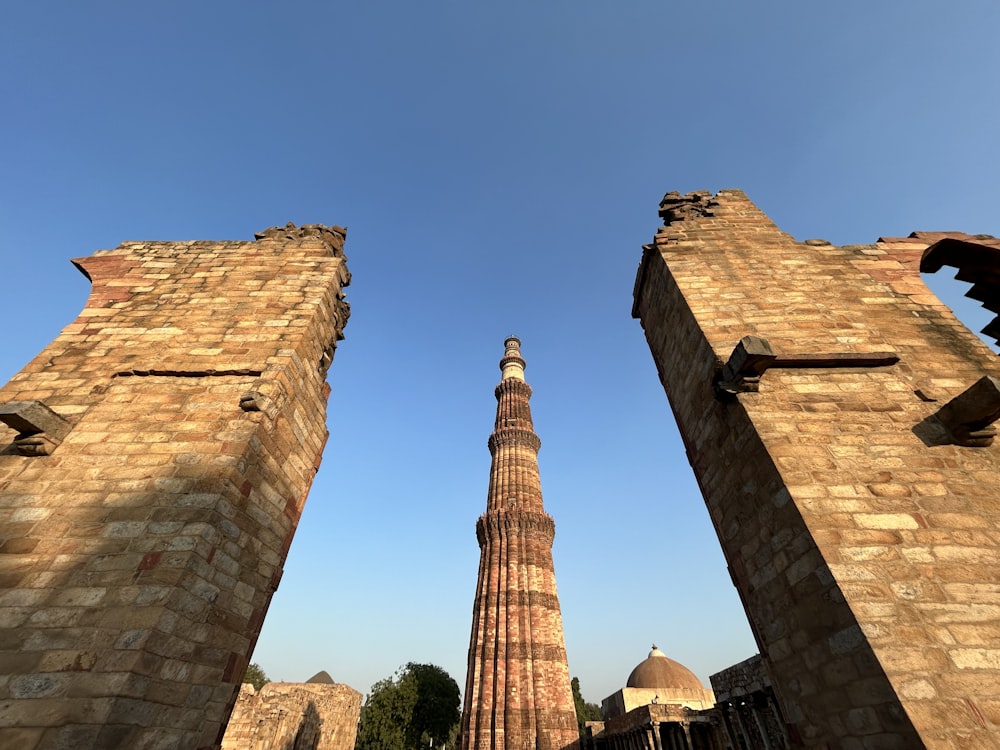 a tall brick tower towering over a city