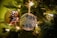 A close-up of a beautifully crafted ornament made from vintage beads and brooches.