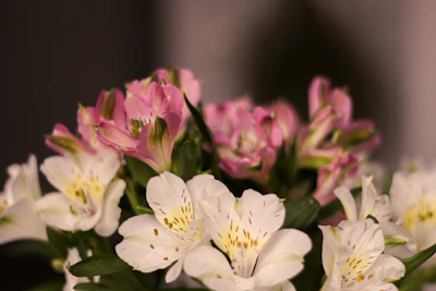 A close-up of delicate gold accents woven through a lush bouquet of mixed flowers.