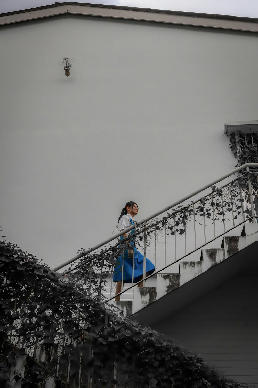 a woman walking down a set of stairs