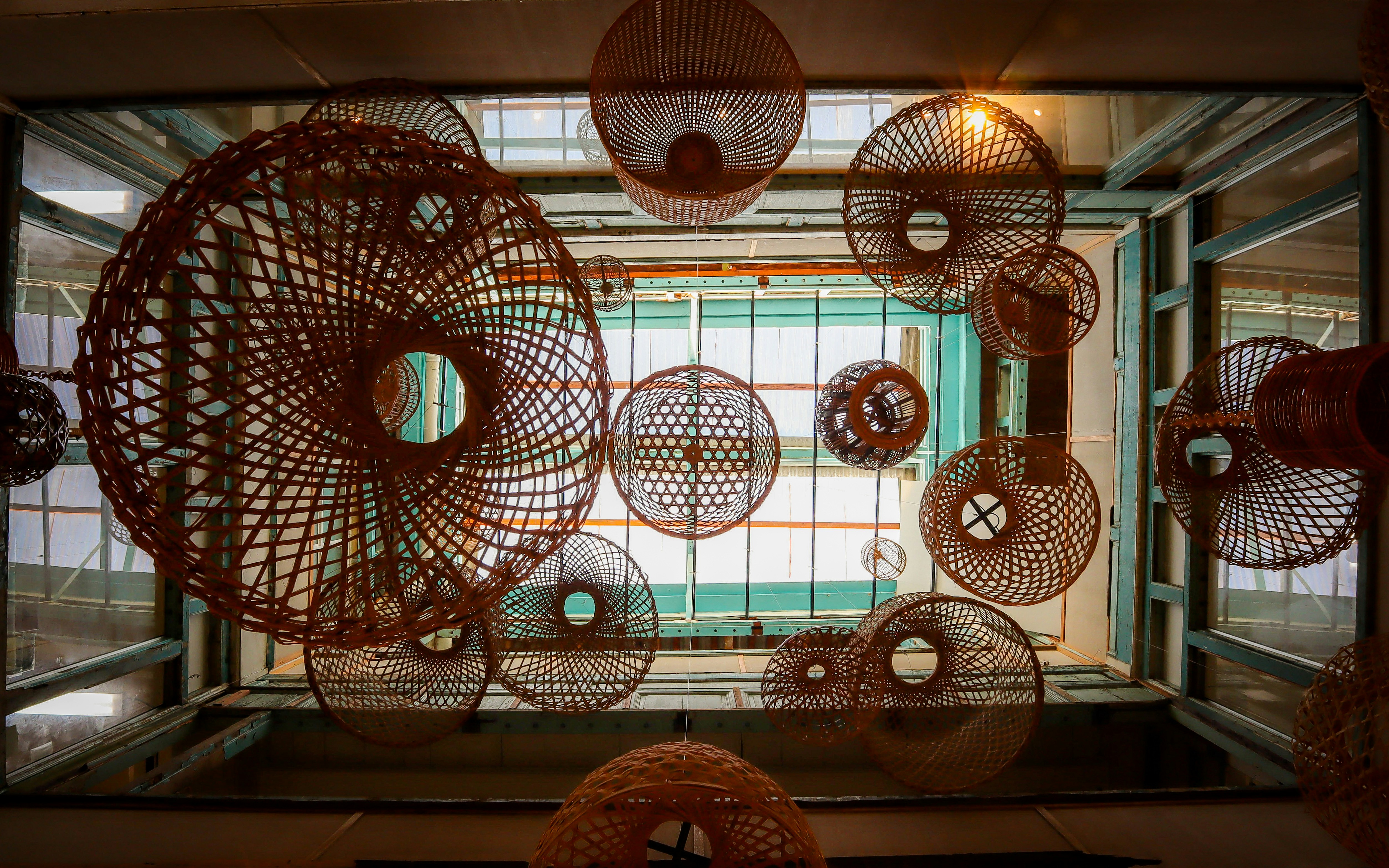 A room with a bunch of round objects hanging from the ceiling photo ...