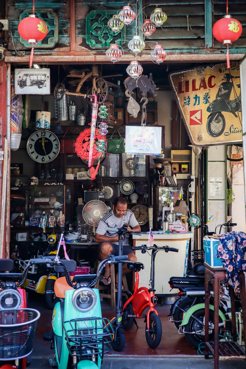 a man sitting at a table in front of a store