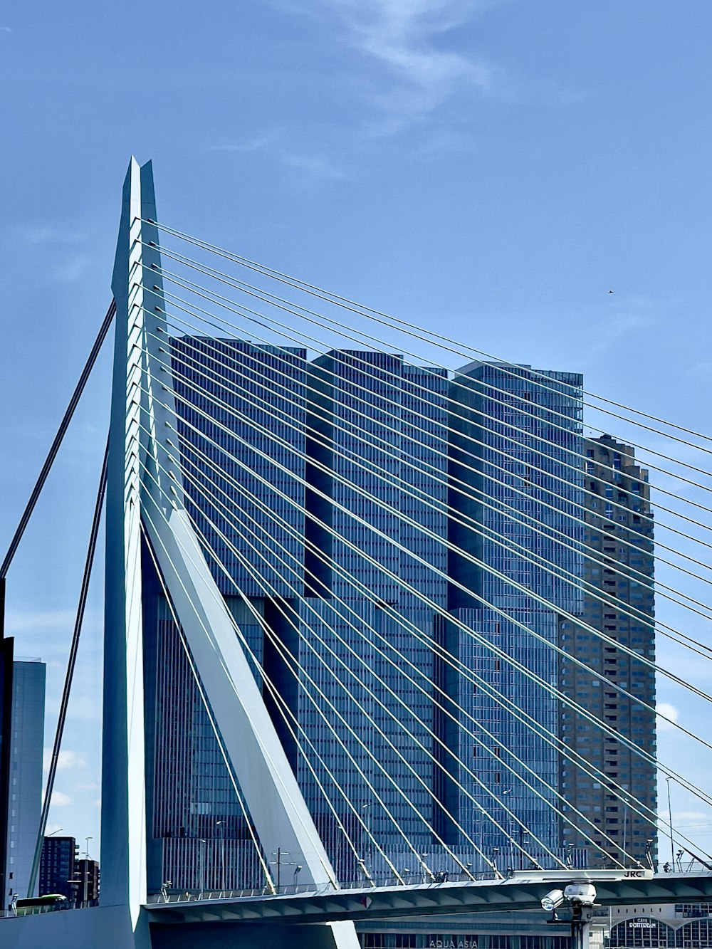 a very tall bridge with a very tall building in the background