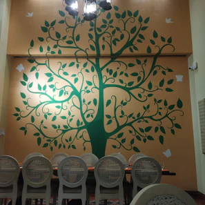 An elegant dining area highlighted by a large, colorful wall hanging decor piece from muralis.