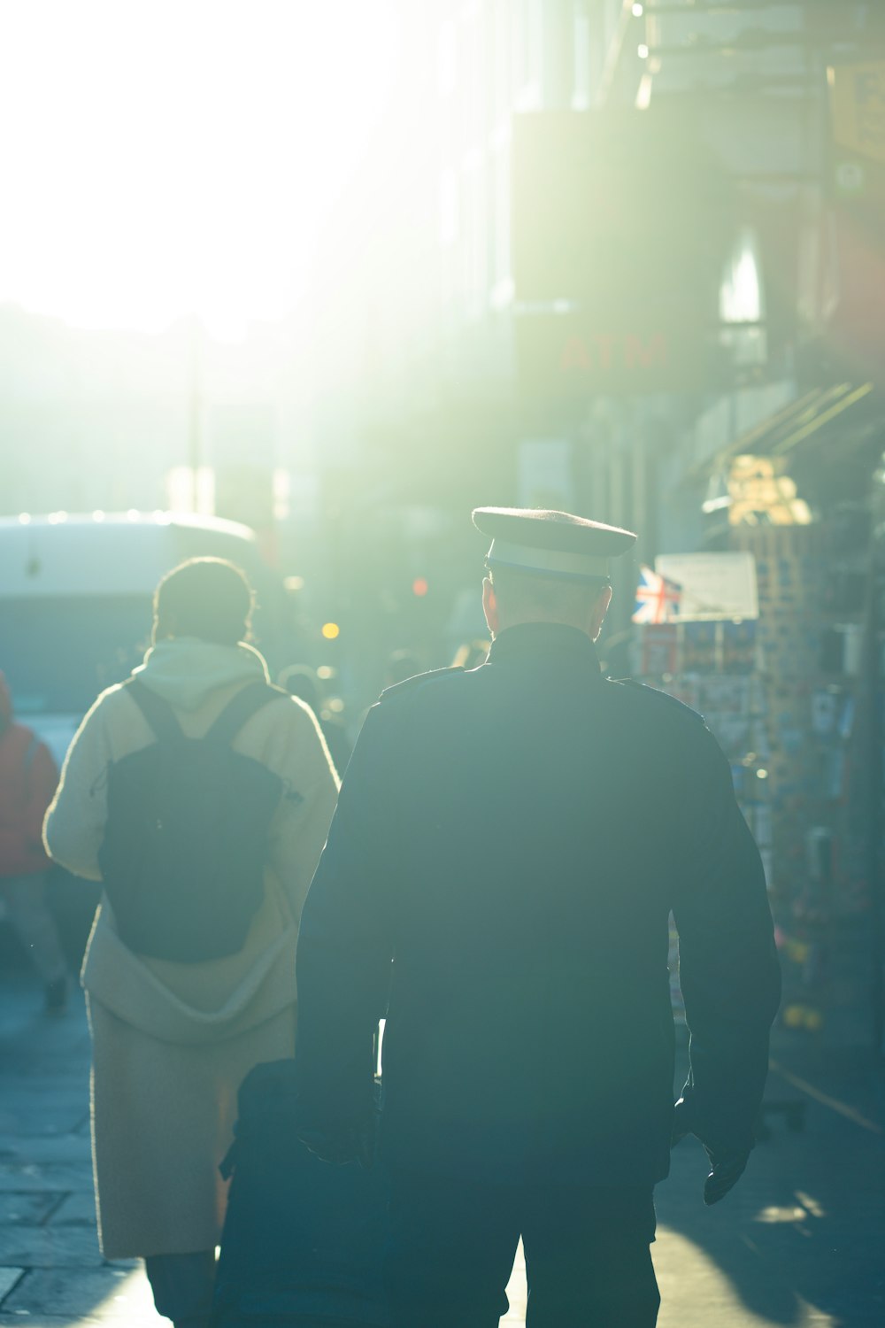 a couple of people walking down a street