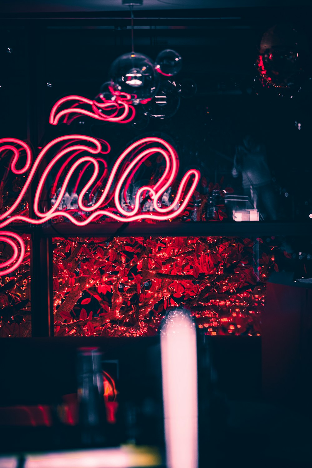 a neon sign in a dark room with red lights
