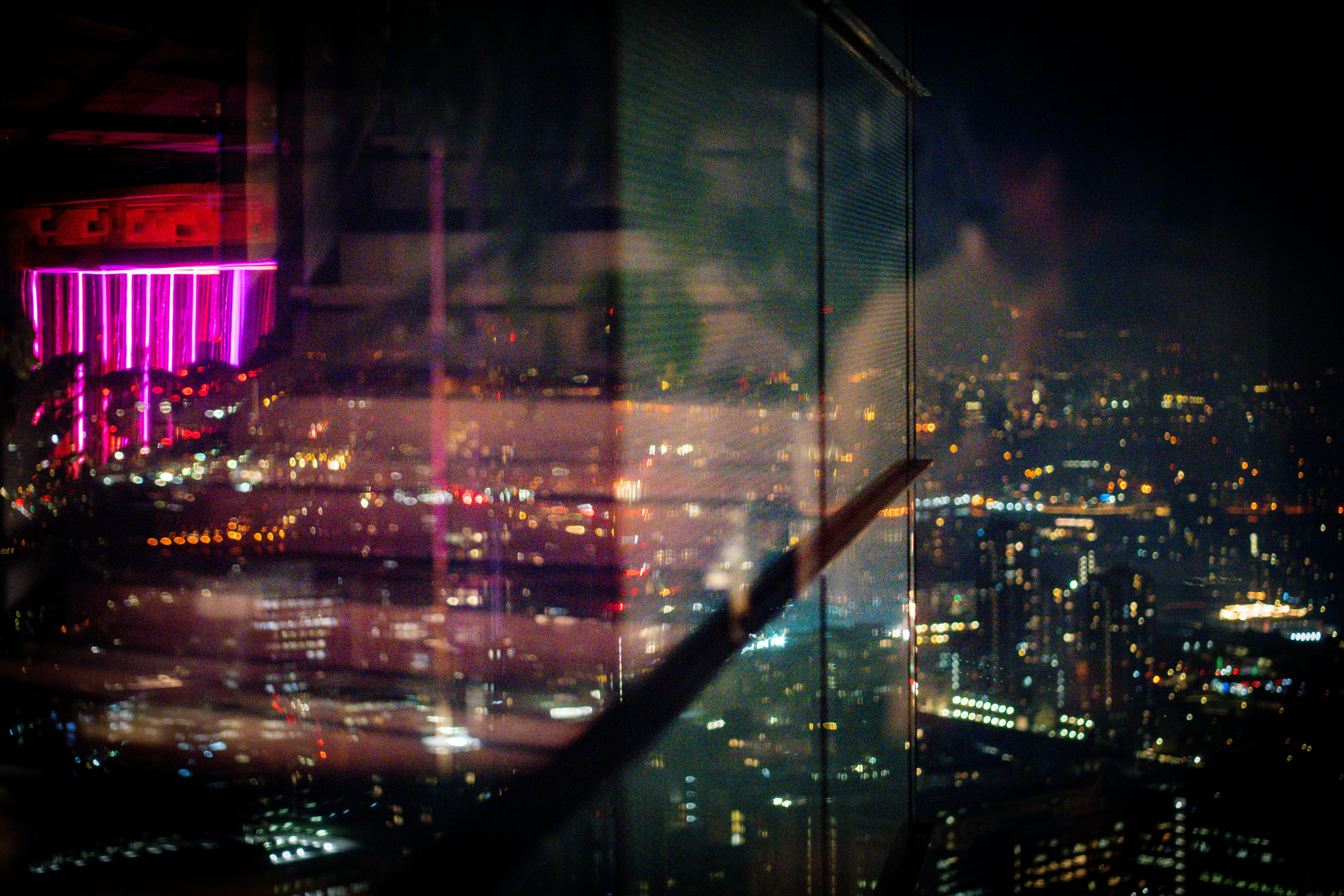 a view of a city at night from a skyscraper
