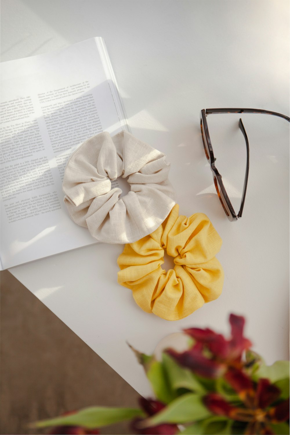 a pair of glasses and a hair scrunch on a table