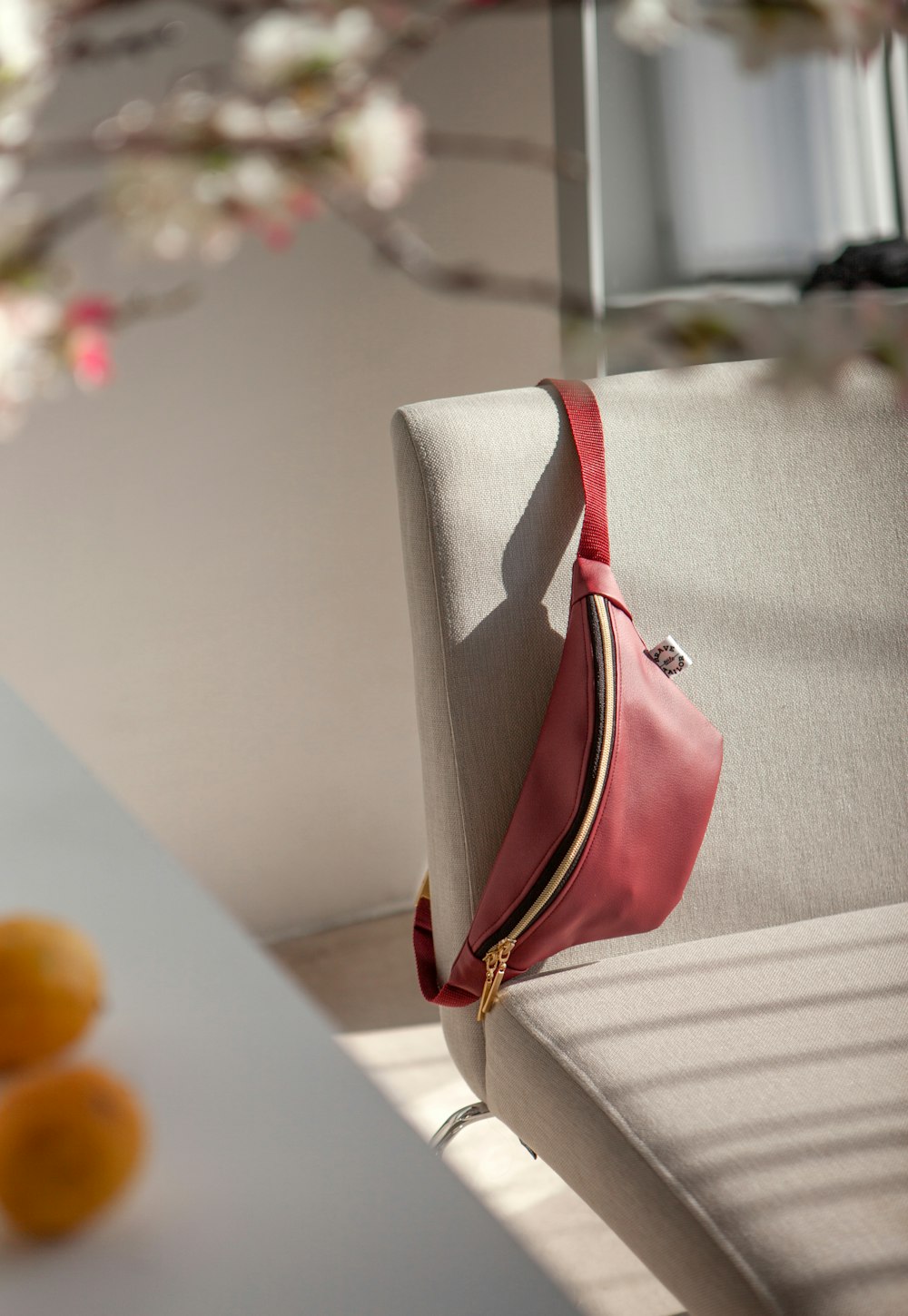 a pink purse sitting on top of a white bench