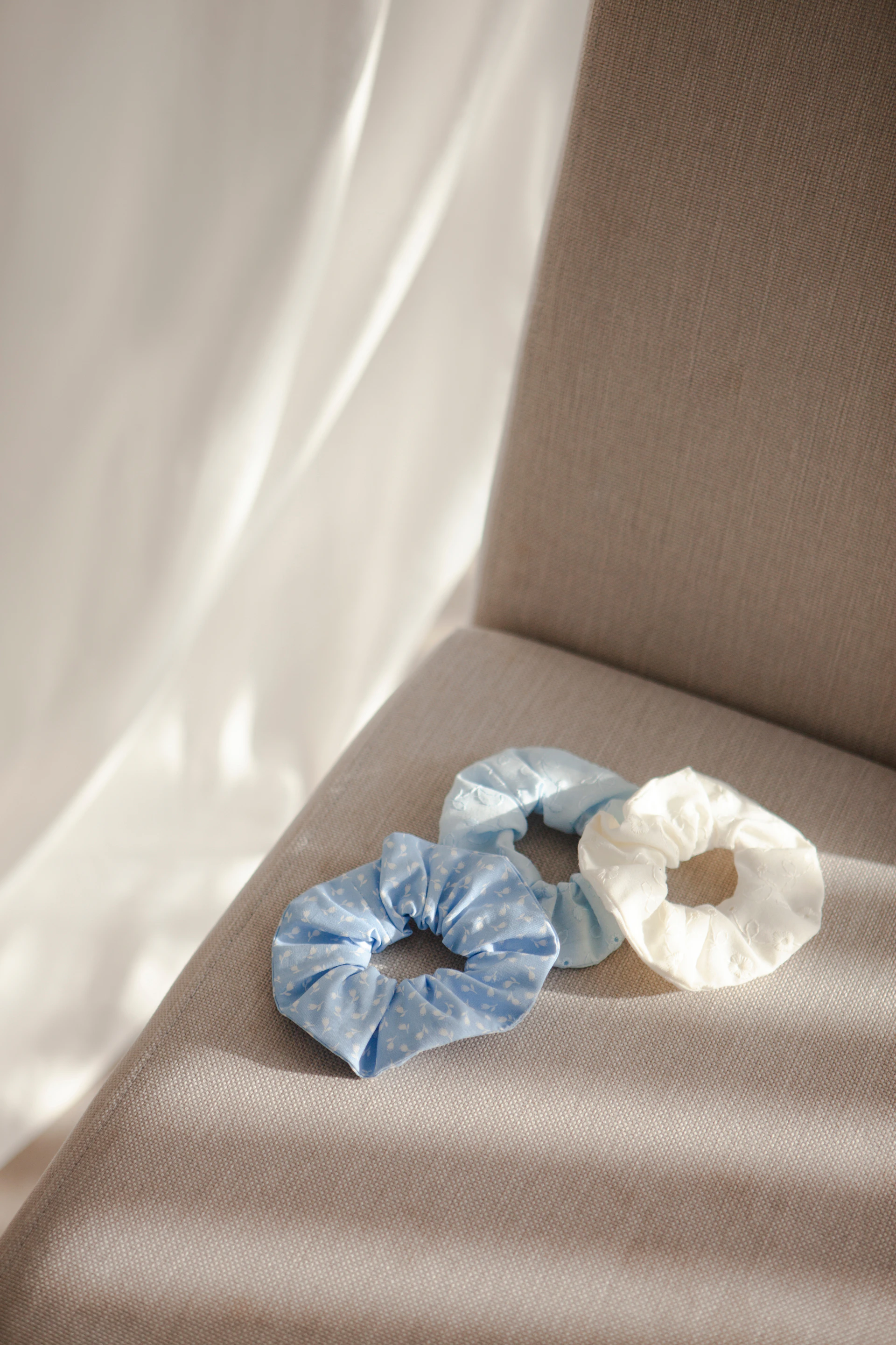 a pair of scrunchy hair ties sitting on a chair