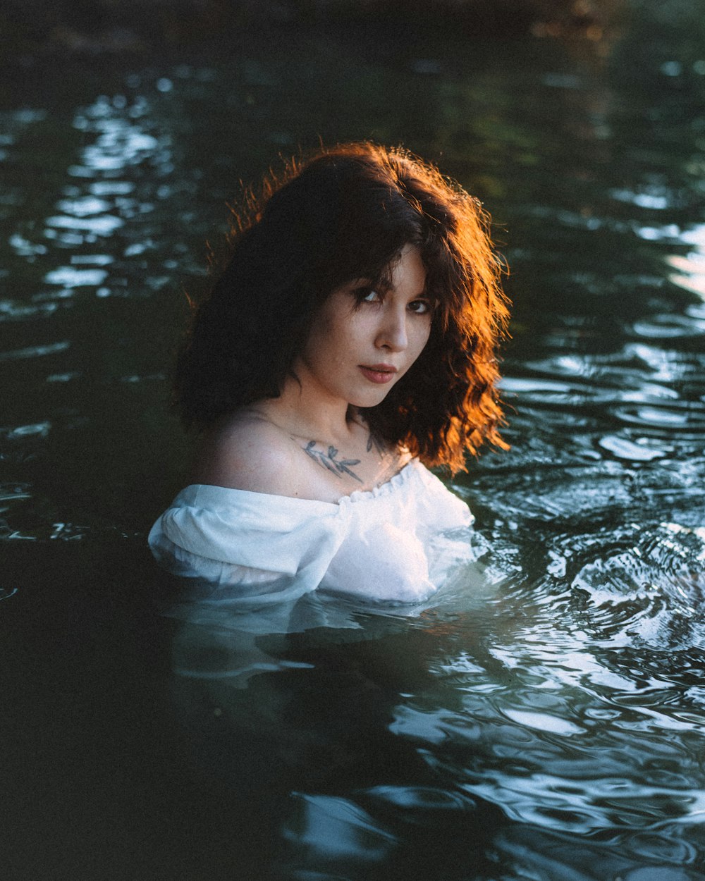 a woman in a white shirt in a body of water