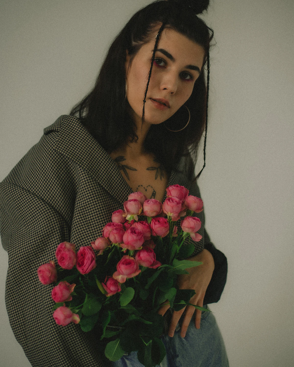 Elegant woman holding pink roses, representing the Ivy's Beauty Secret experience