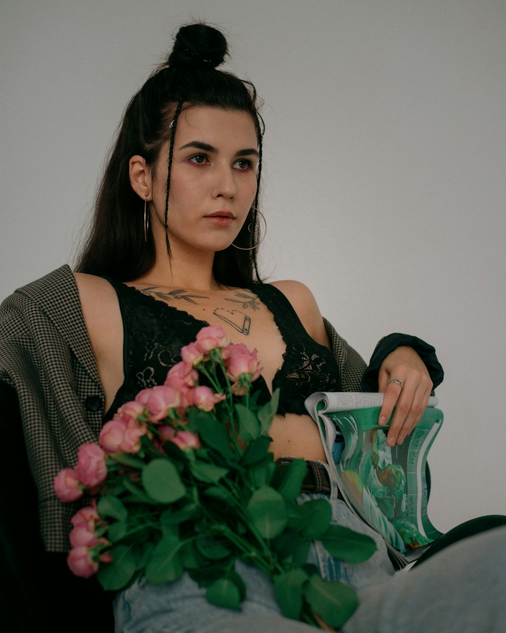 a woman sitting on a couch with a bouquet of flowers