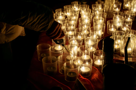 a table topped with lots of lit candles