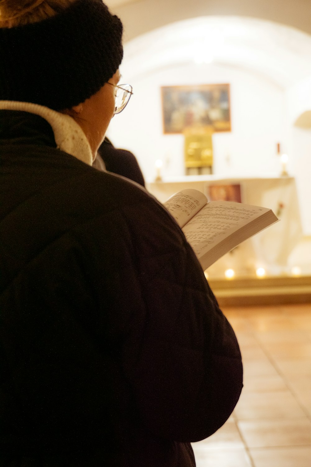 a woman reading a book in a church