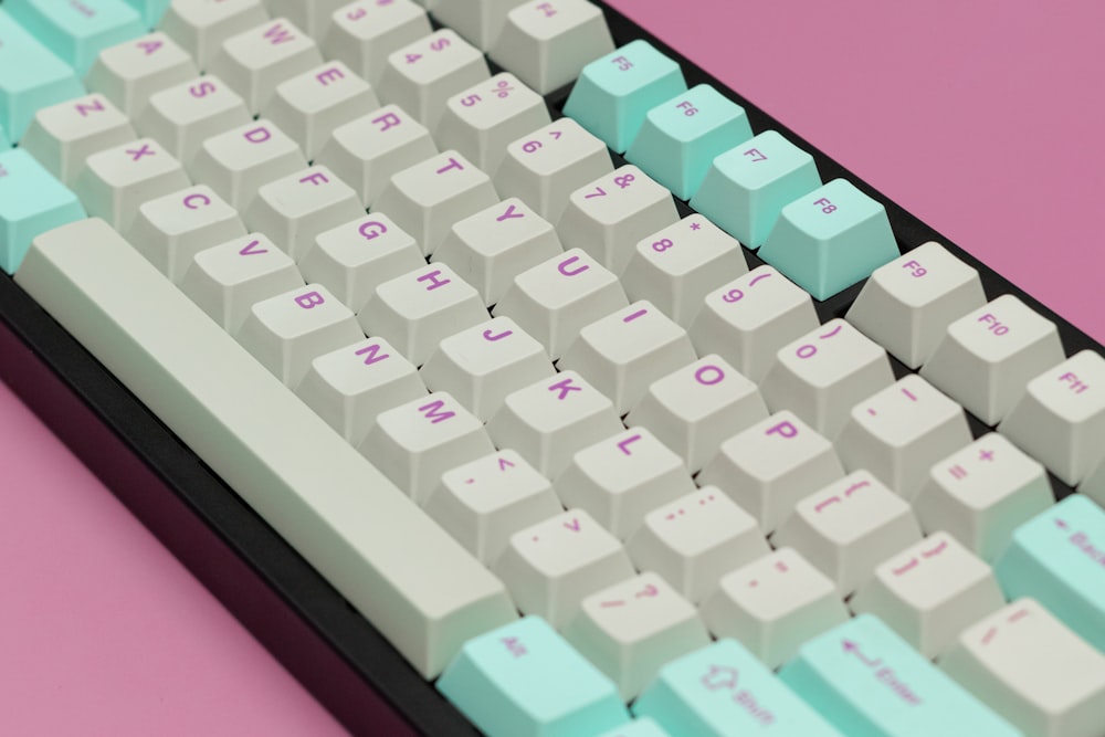 a close up of a keyboard on a pink background