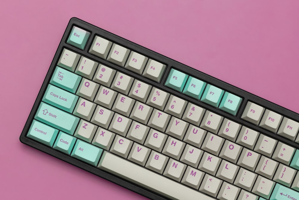 a close up of a keyboard on a pink background