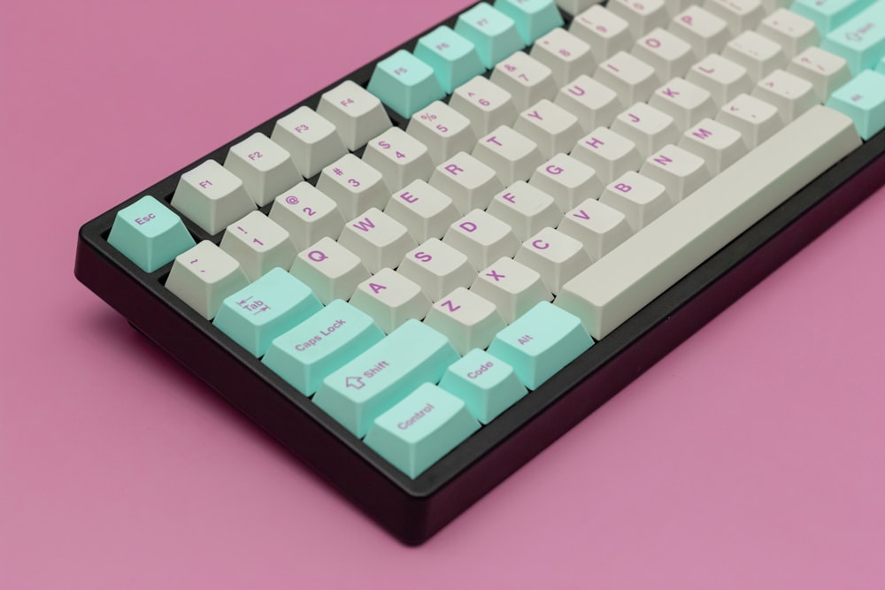 a close up of a keyboard on a pink background