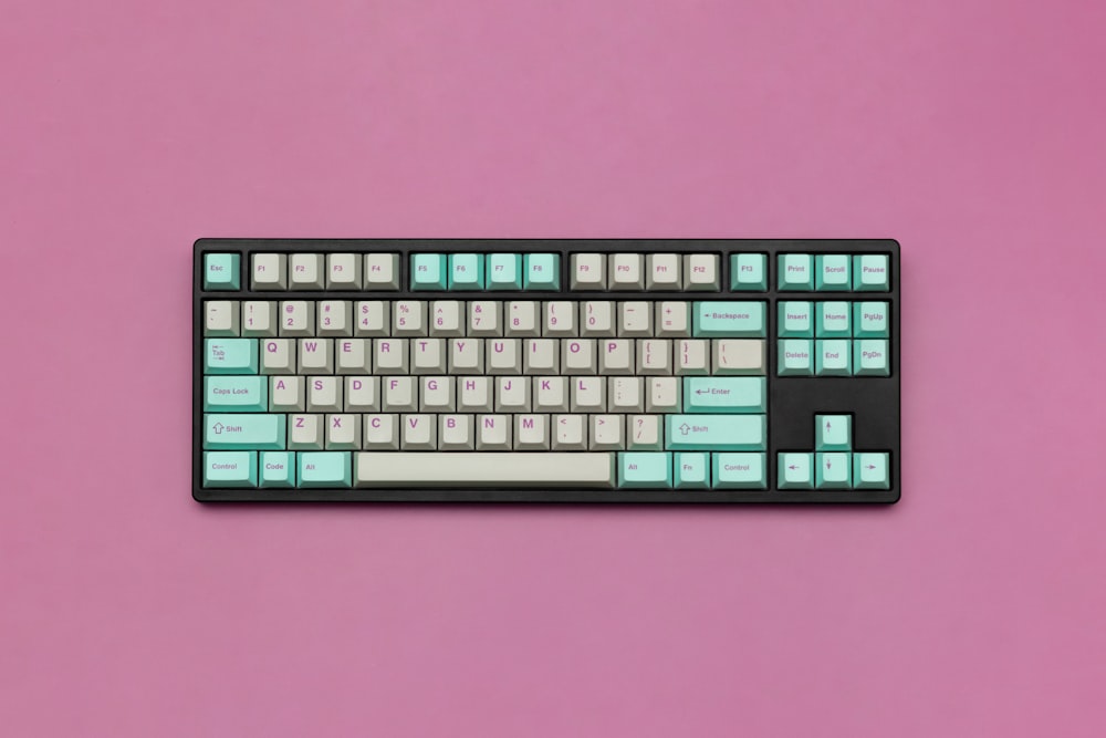 a black and white keyboard on a pink background