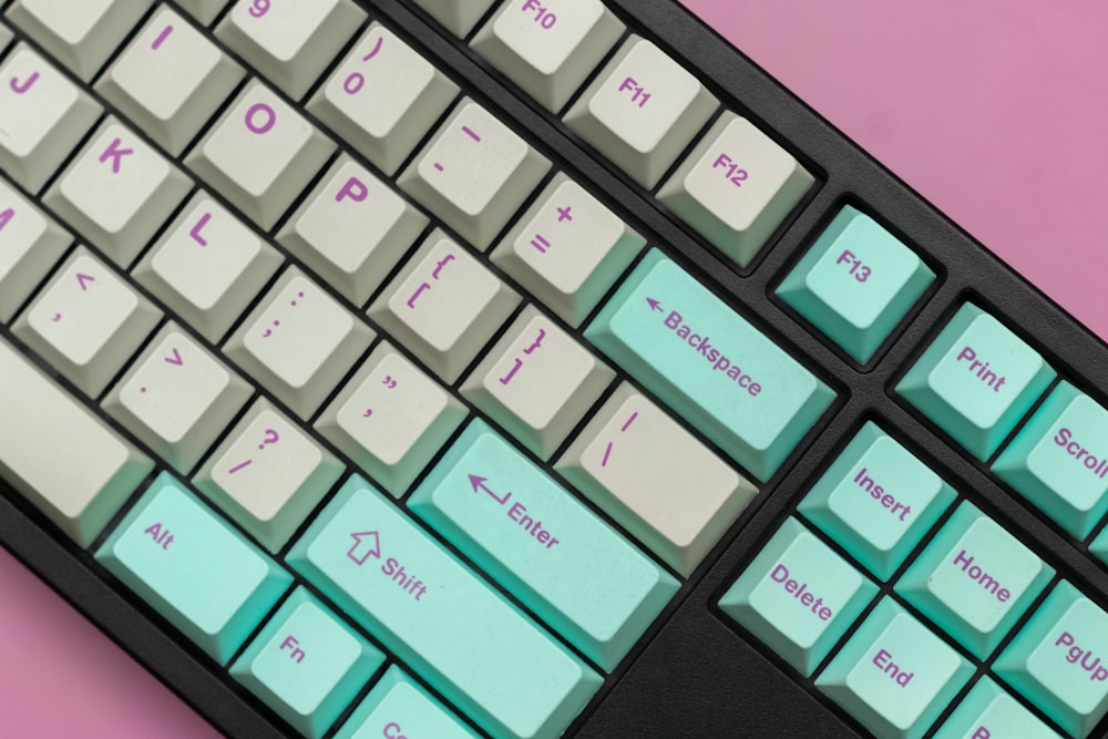 a close up of a keyboard on a pink background