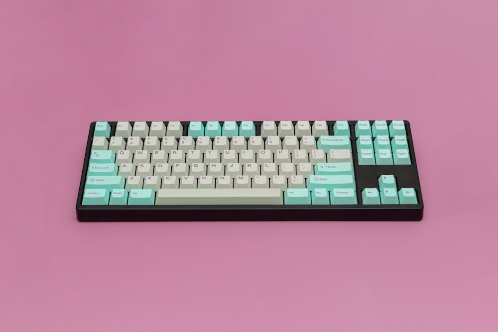 a black and white keyboard on a pink background
