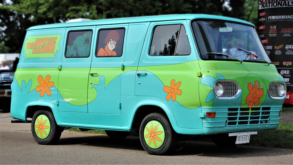 a blue and green van parked on the side of a road