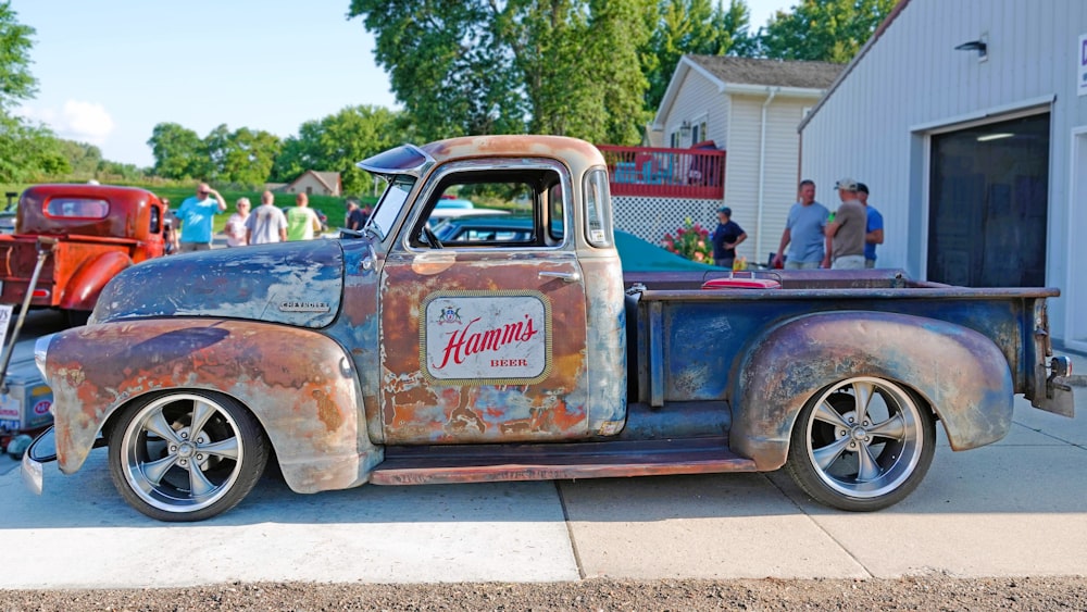 an old truck parked on the side of the road