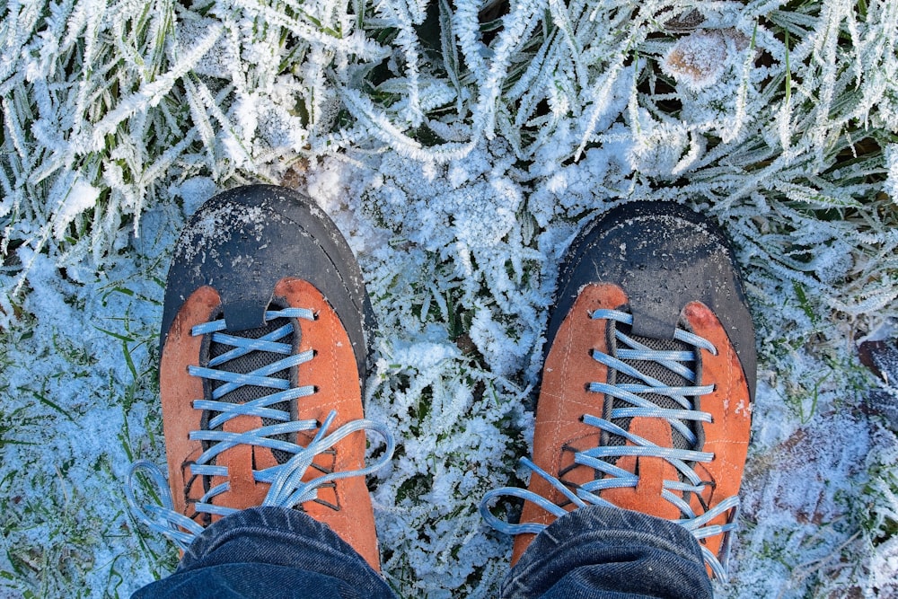 a person standing in the snow wearing hiking shoes