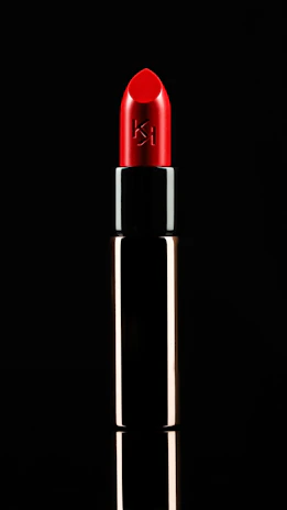 A glossy blue lipstick tube with the cap off, showing a smooth, bold color.