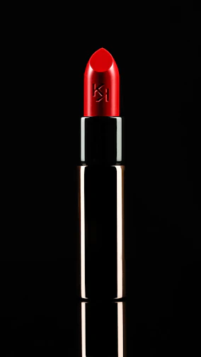 Close-up of vibrant neon pink lipstick on a sleek black tube with gold accents.