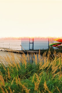 A scenic view of kayaks on a tranquil lake at sunrise.