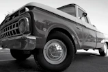 A before and after side-by-side of an old dusty truck transformed into a gleaming vehicle.