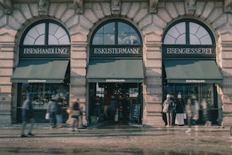 A bustling German storefront with happy customers and vibrant window displays.