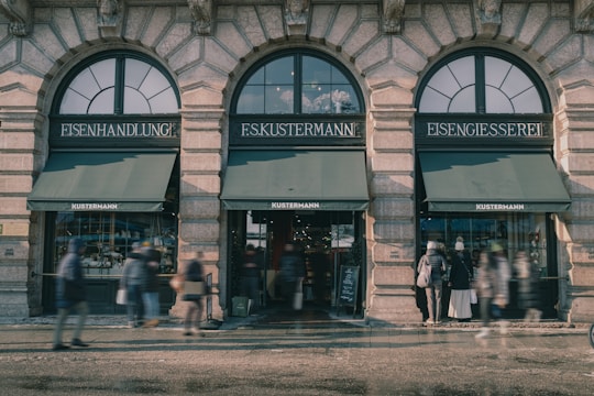 A bustling German storefront with happy customers and vibrant window displays.