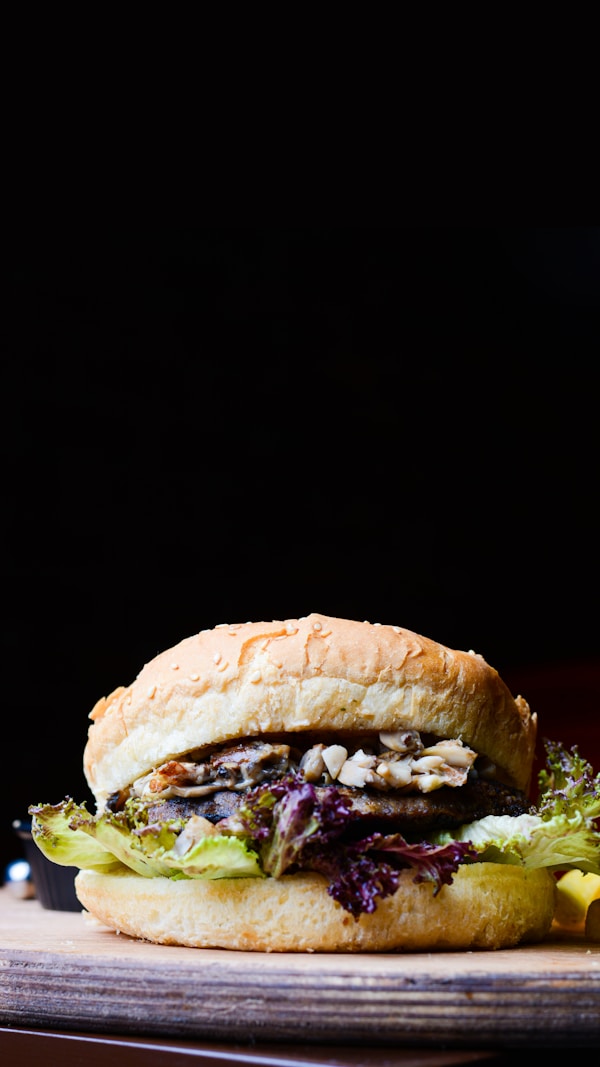 A sandwich with meat, lettuce, and cheese