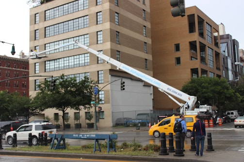 two men are working on a street light