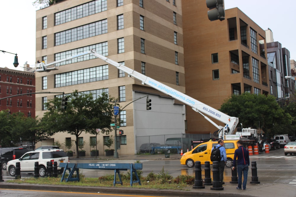 two men are working on a street light